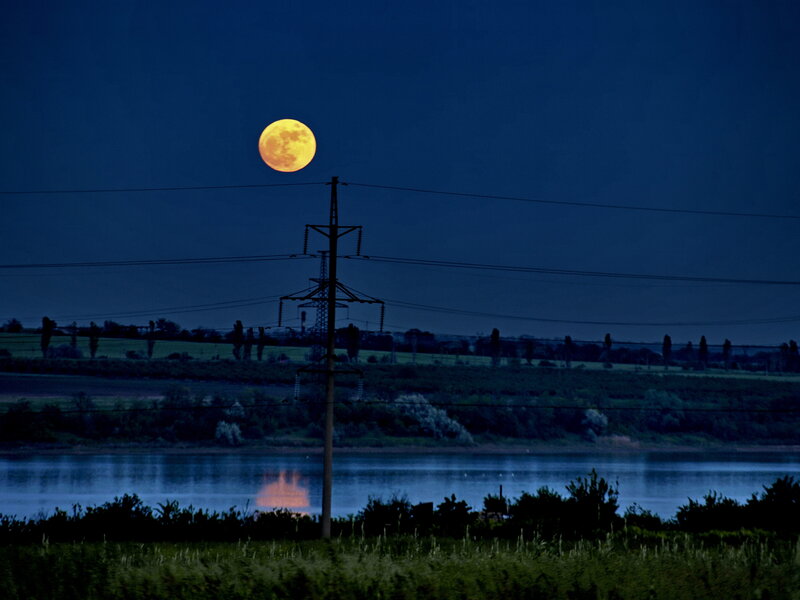 Moon over river landscape