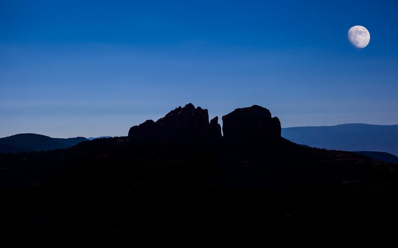 Moon over rock formations