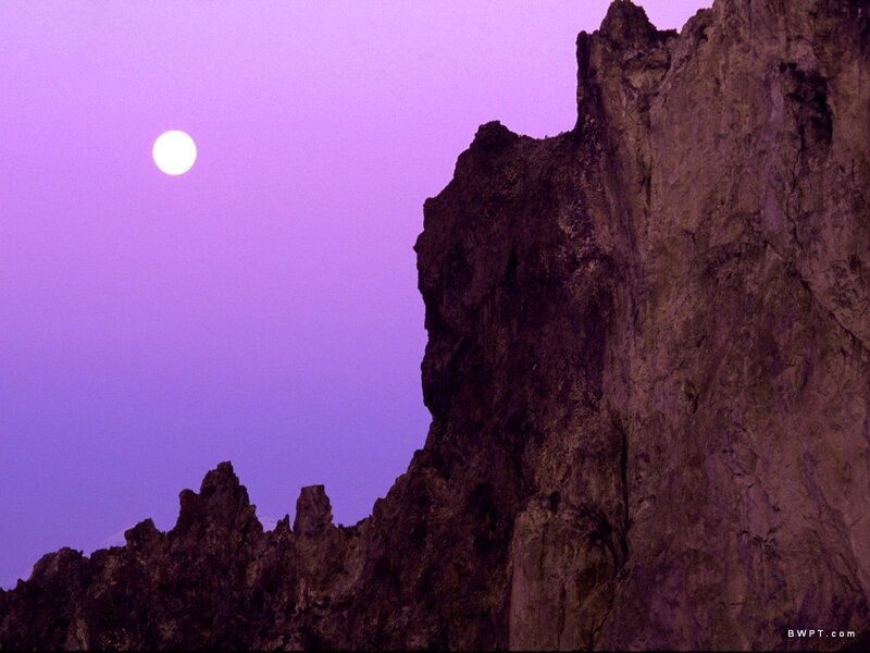 Moon over rocky cliffs