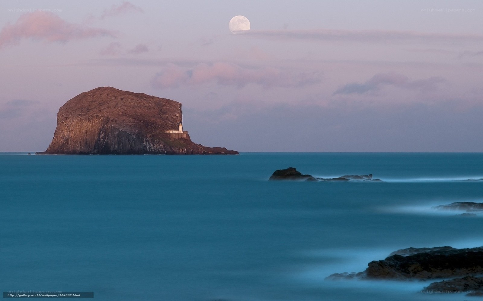 Moon over rocky island
