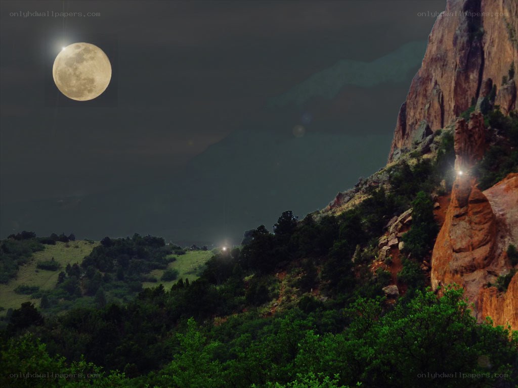 Moon over rocky landscape