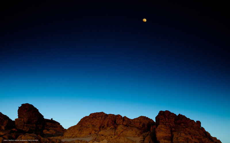Moon over rocky landscape
