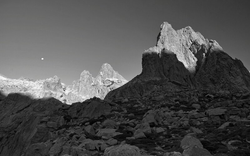 Moon over rocky peaks