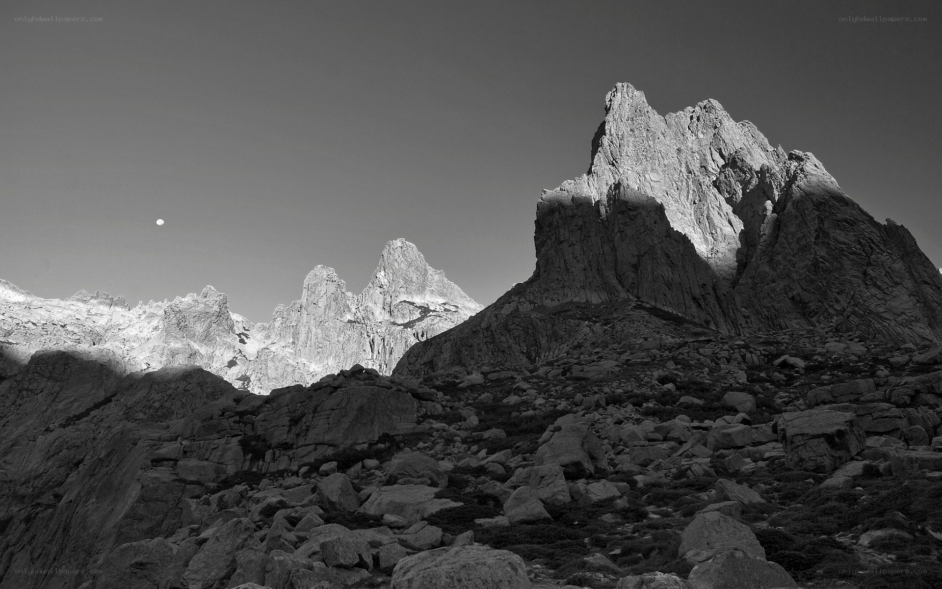 Moon over rocky peaks