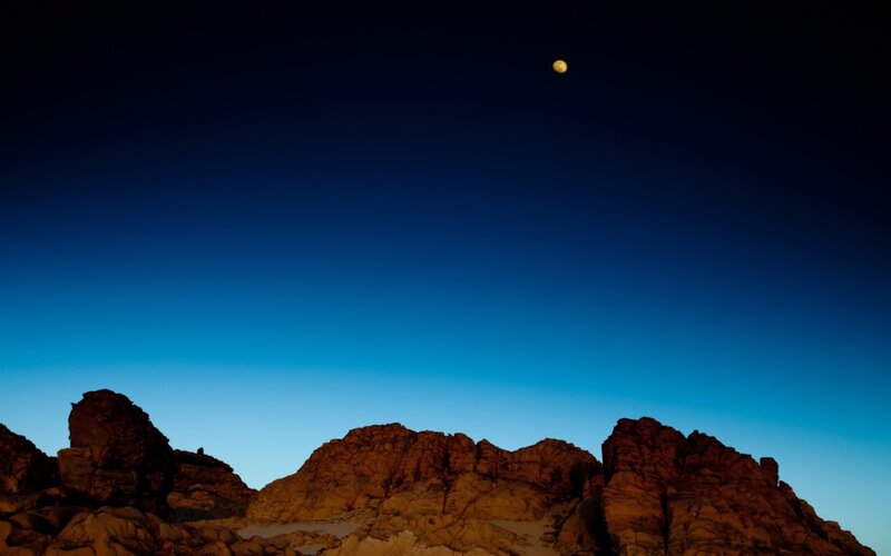 Moon over Rocky Terrain
