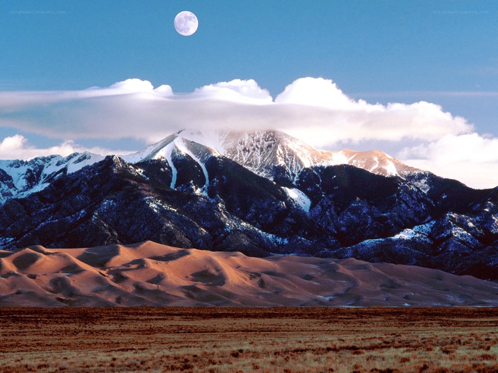 Moon over Sand Dunes and Mountains