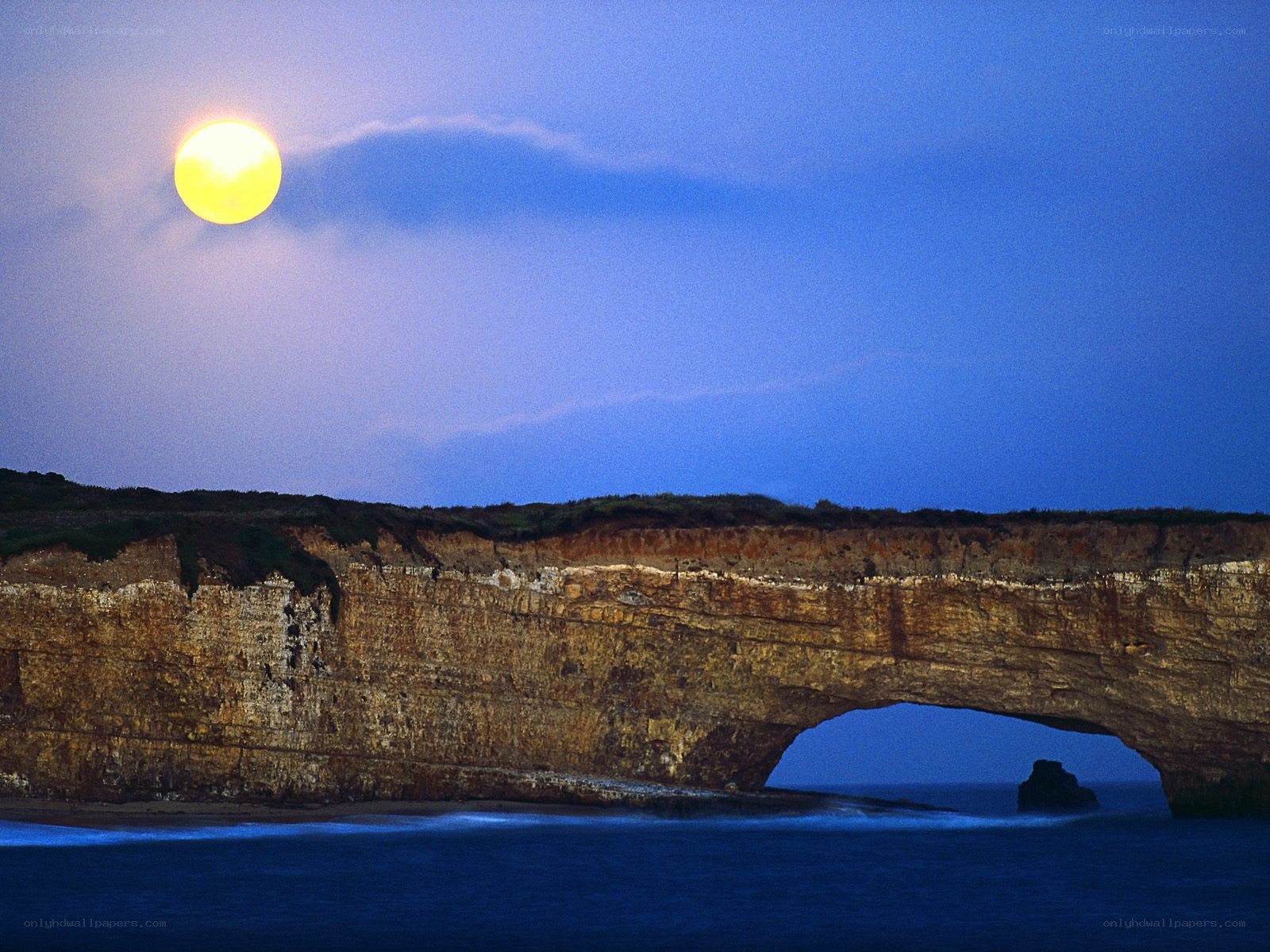 Moon over sea arch
