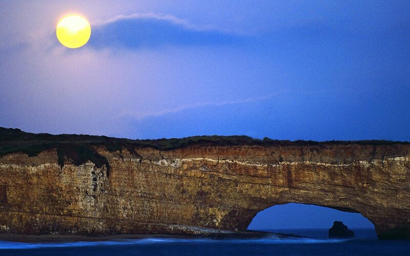 Moon over sea arch