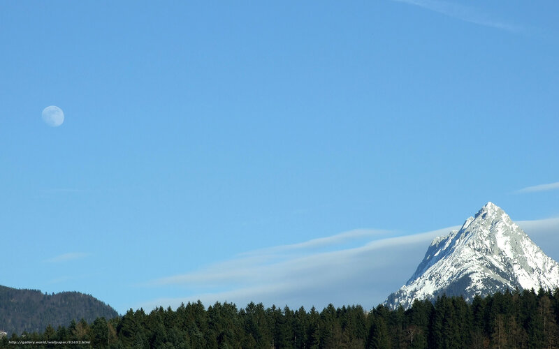 Moon over snow-capped mountain