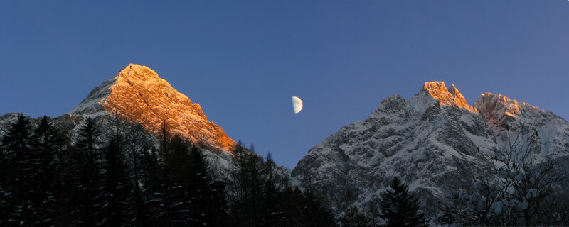 Moon over snow-capped mountains