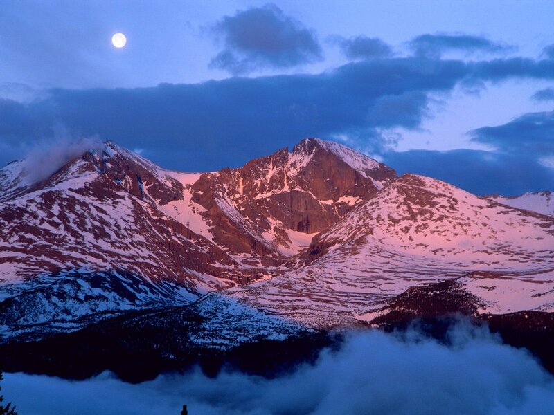 Moon over snow-capped mountains