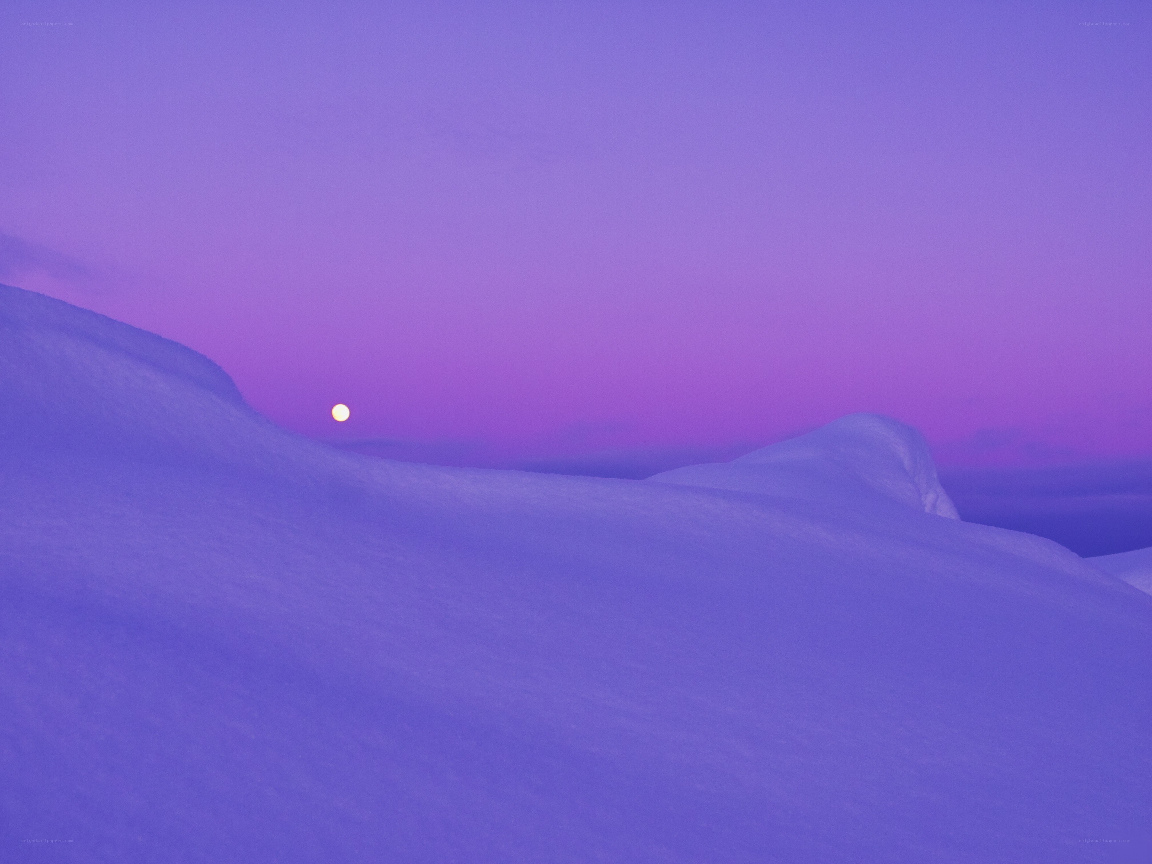 Moon over snowy hills