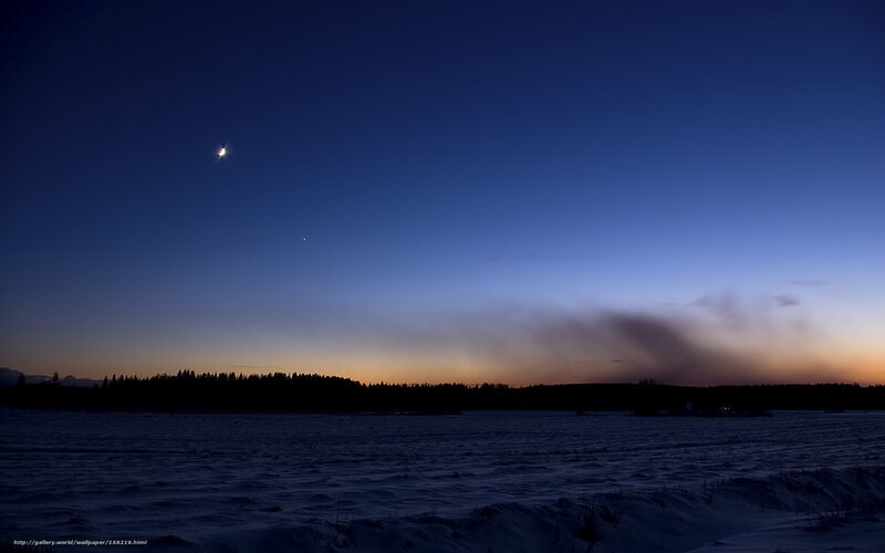 Moon over snowy landscape