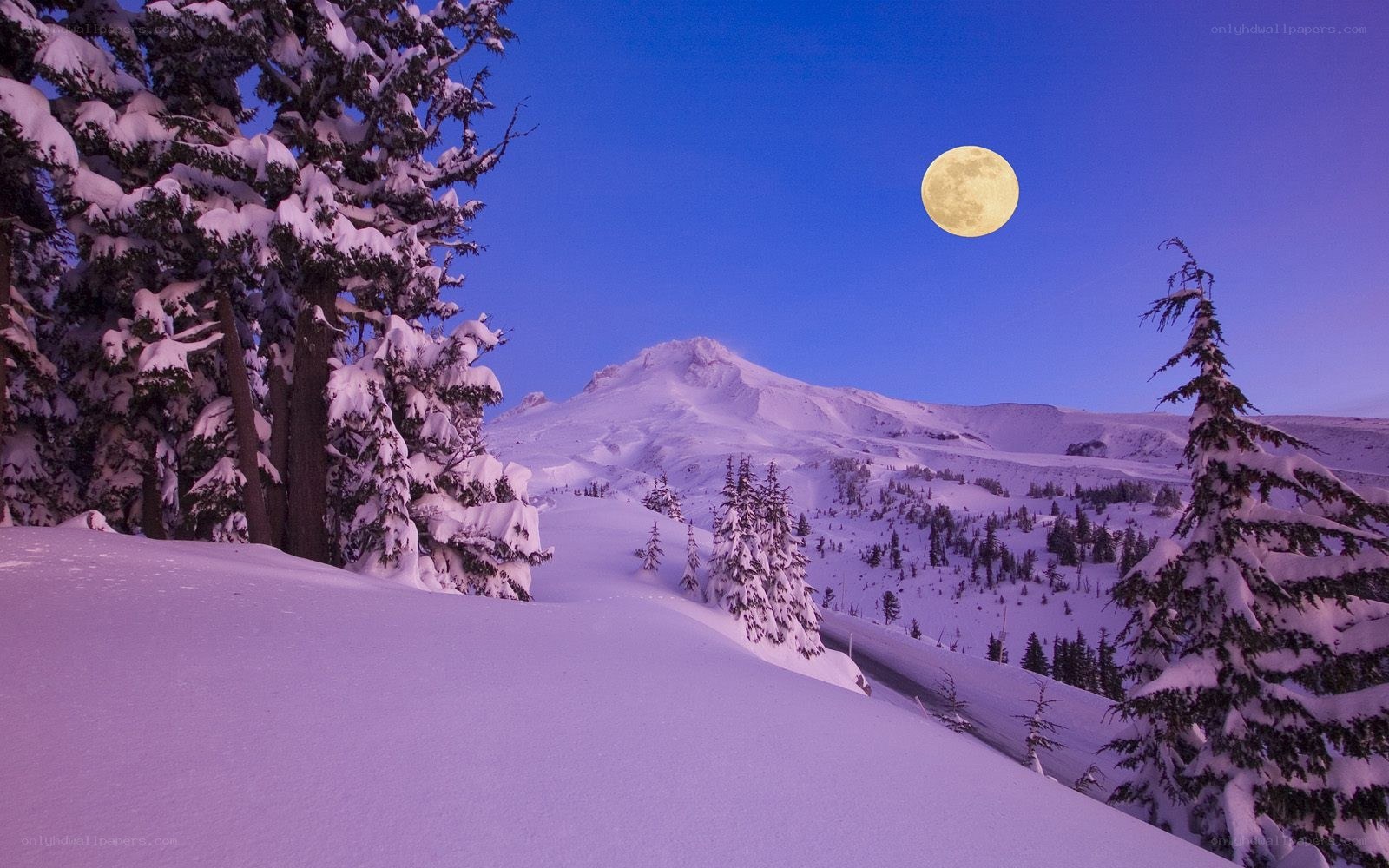 Moon over snowy mountain