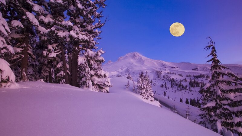 Moon over snowy mountain