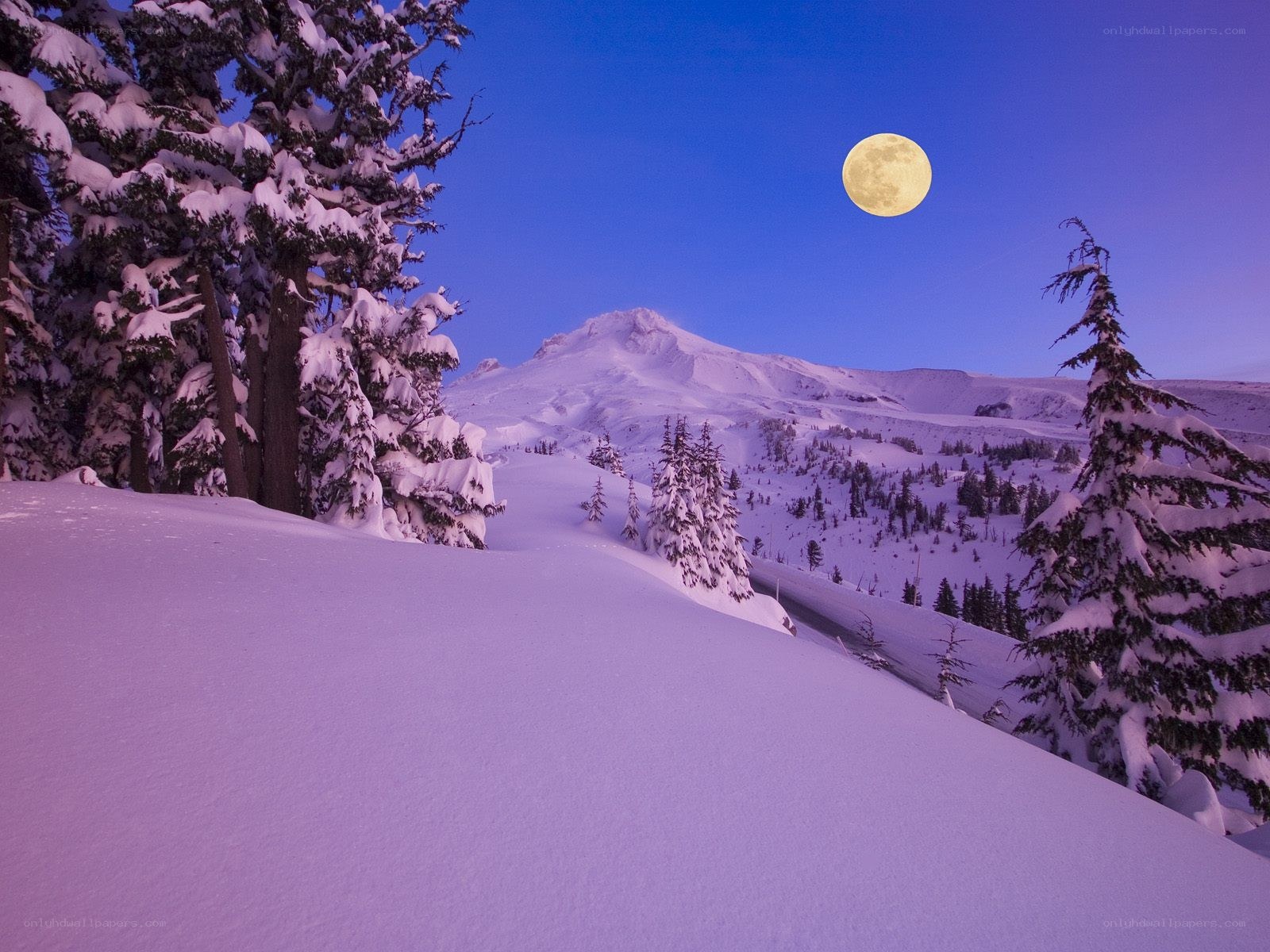 Moon over snowy mountain