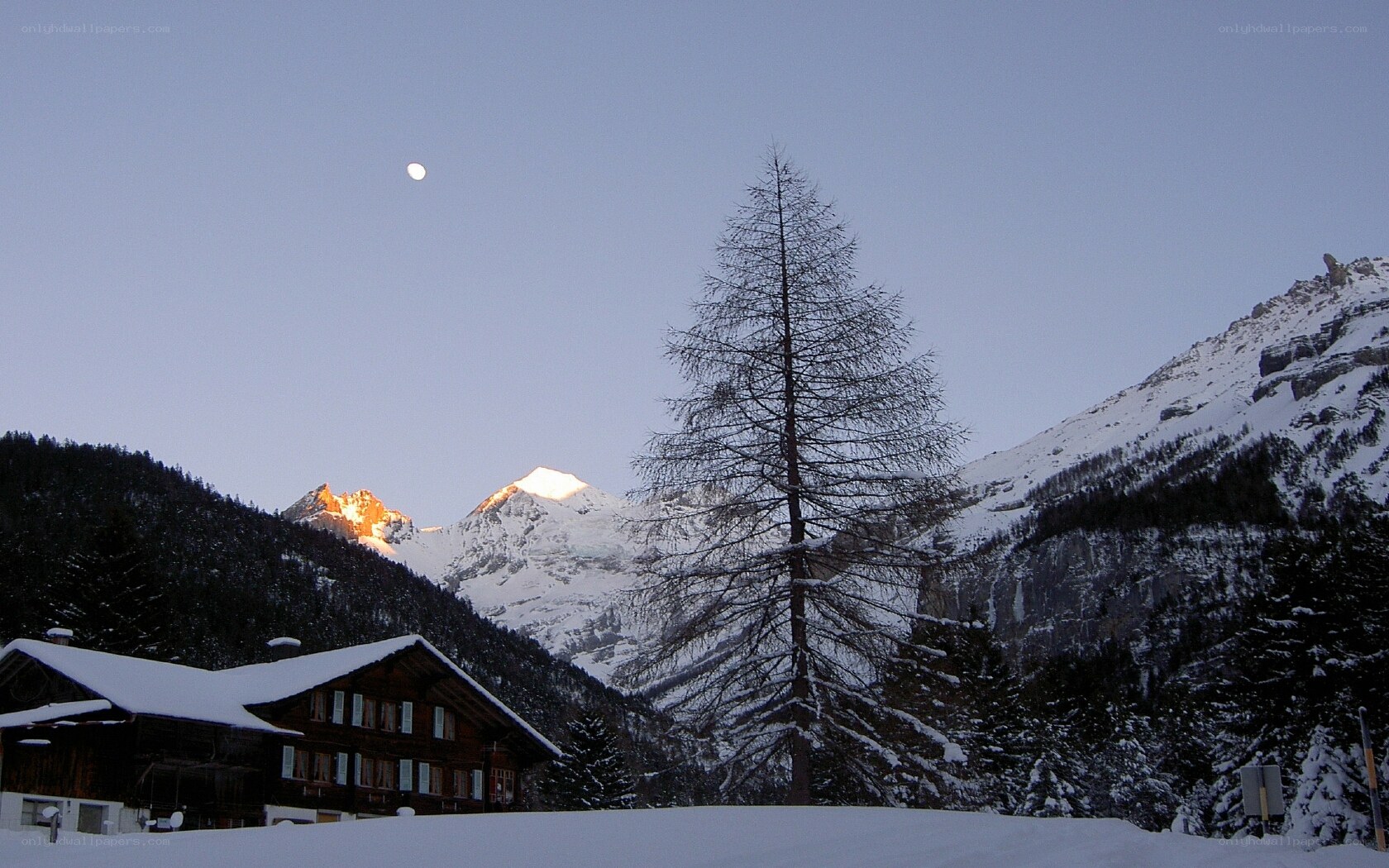 Moon over snowy mountains