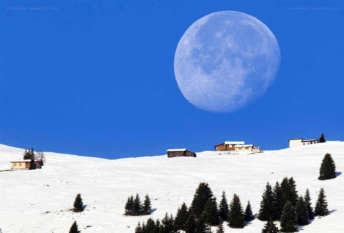 Moon over snowy mountains