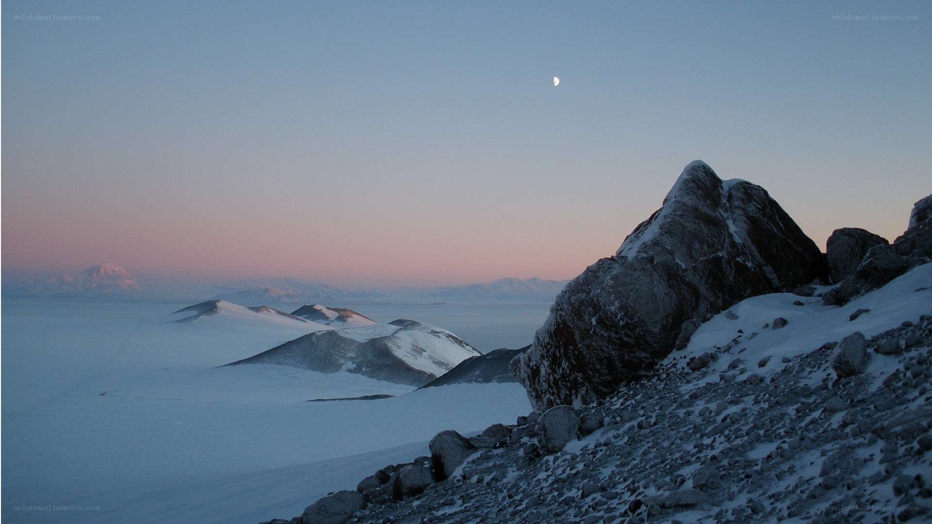 Moon over snowy mountains