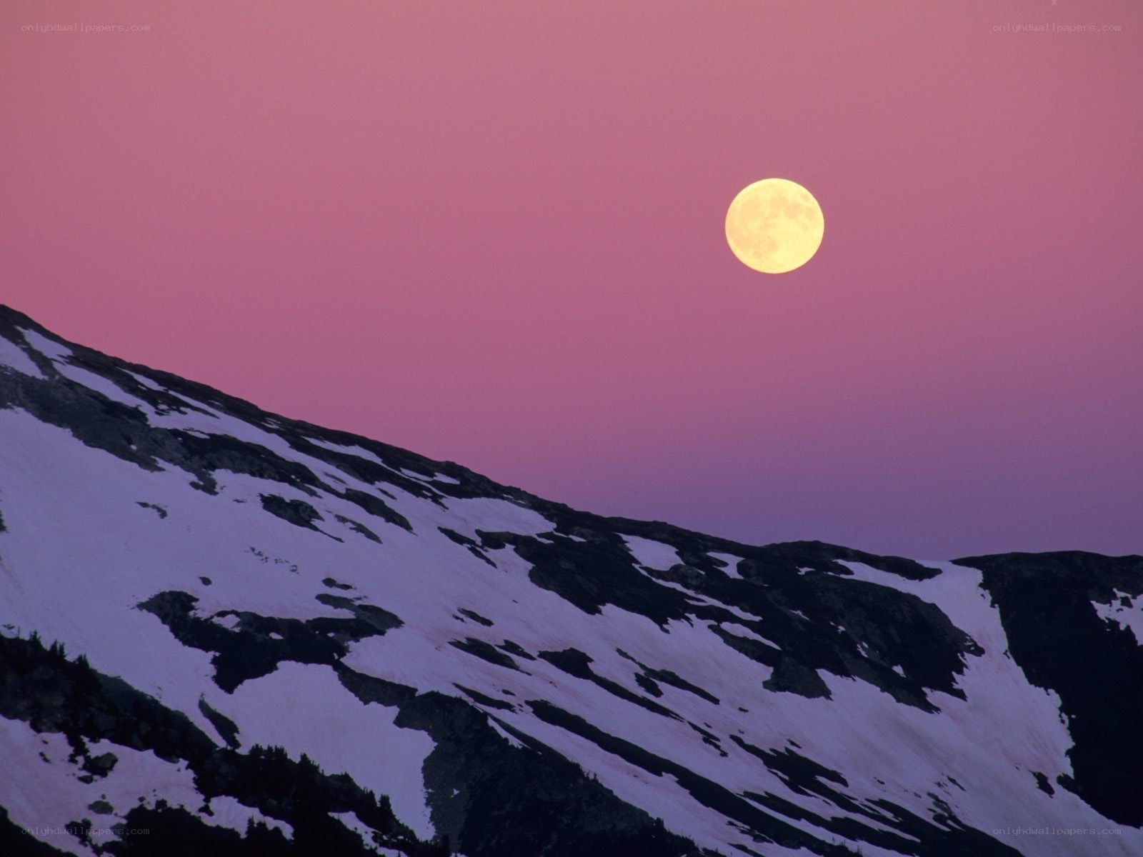 Moon over snowy mountains