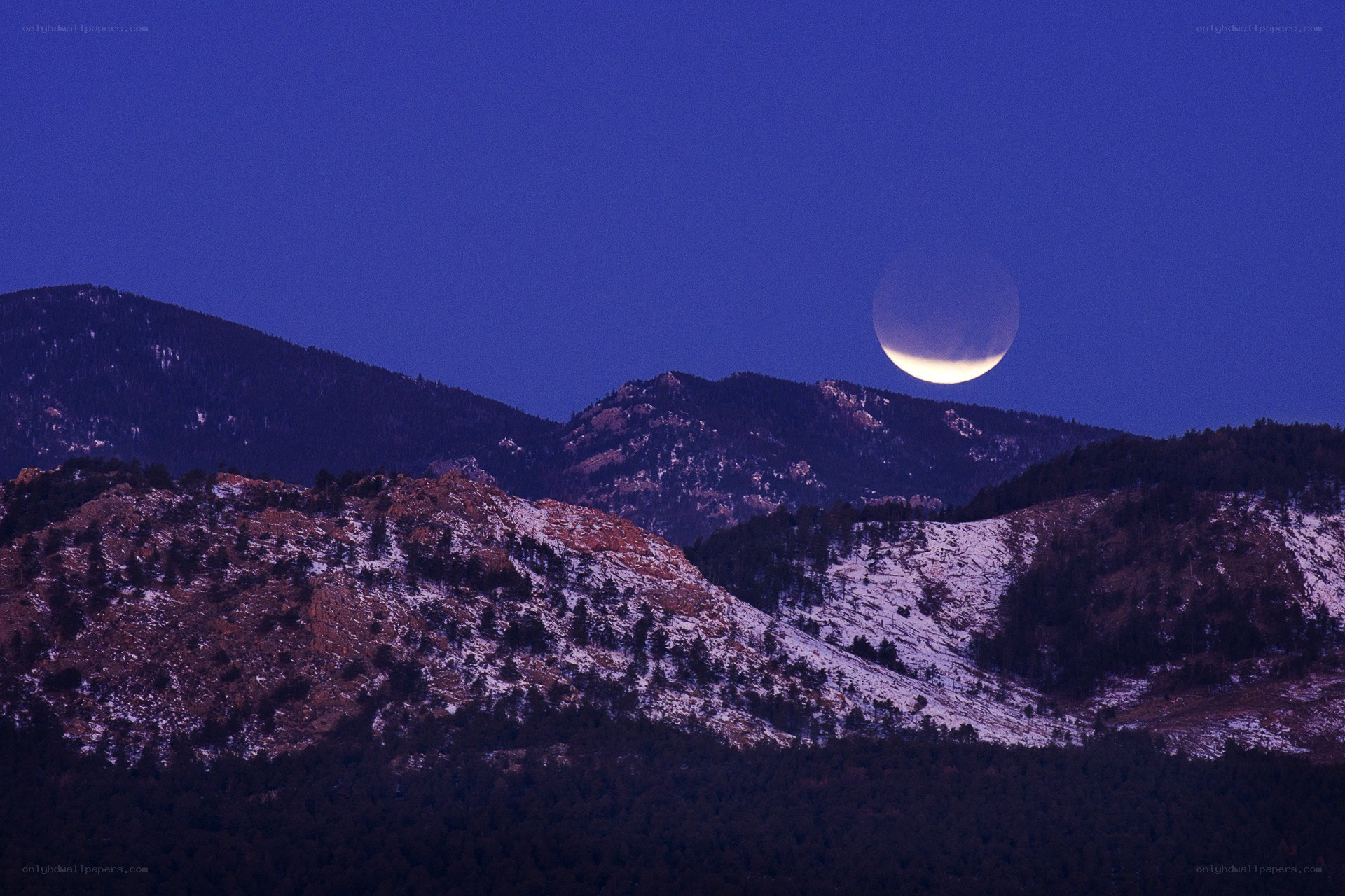 Moon over snowy mountains