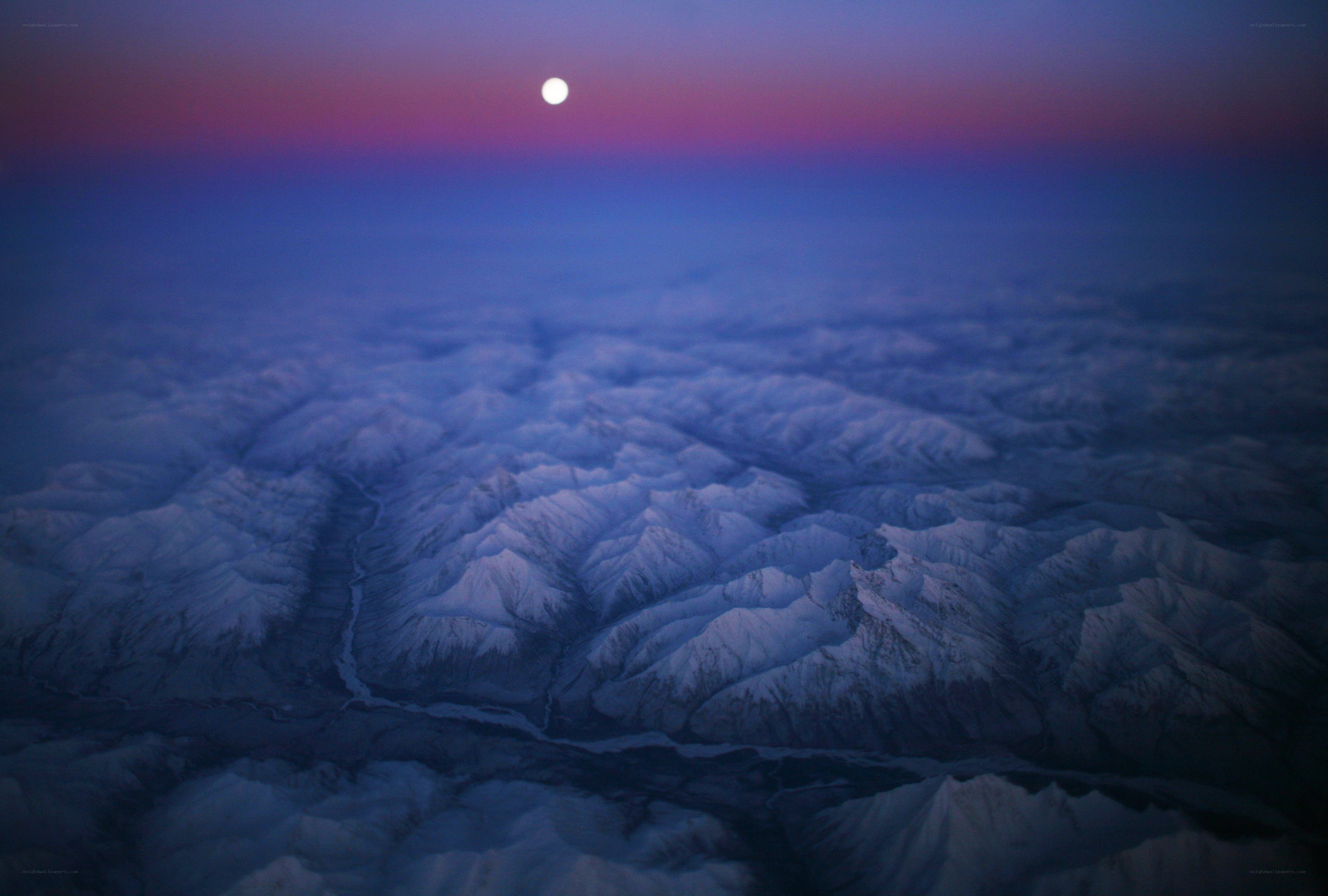 Moon over snowy mountains