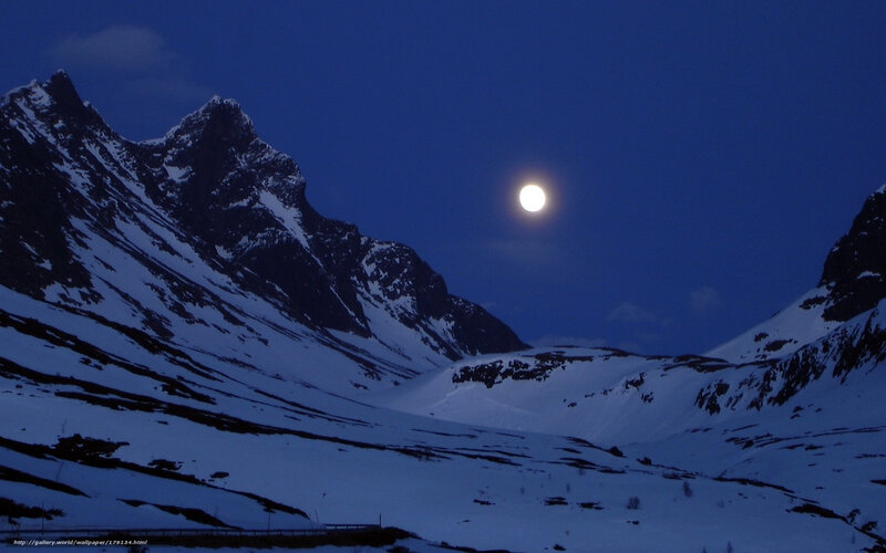 Moon over snowy mountains