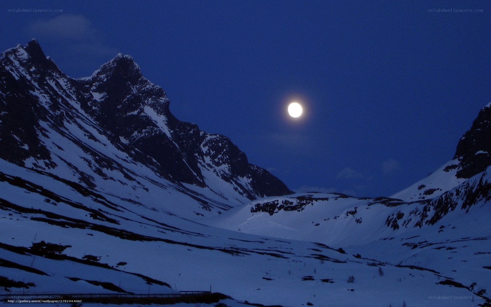 Moon over snowy mountains