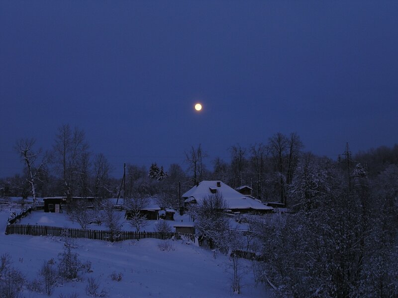 Moon over snowy village