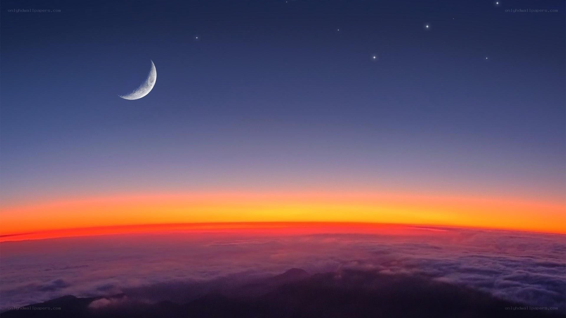 Moon over sunset clouds