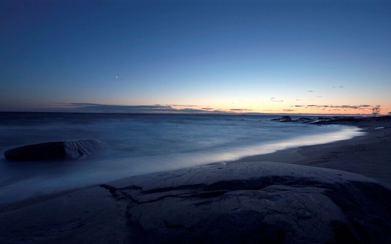 Moon over the ocean at dusk