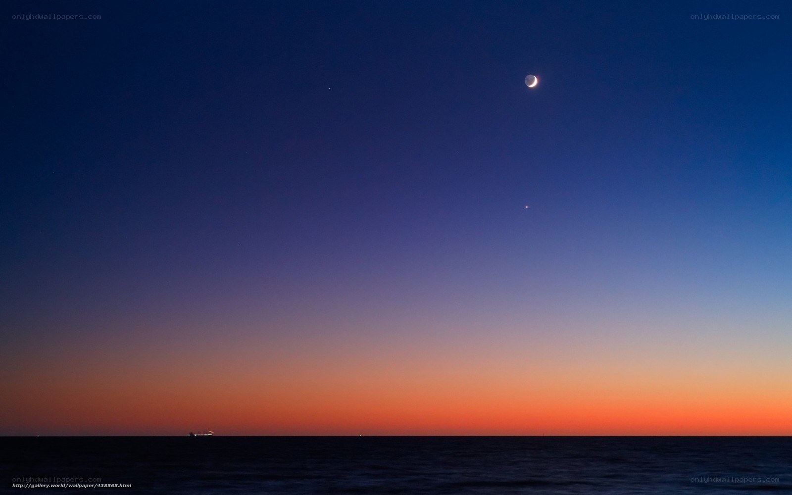 Moon over the ocean at dusk