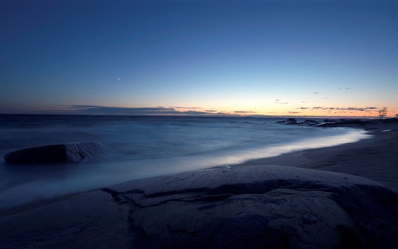 Moon over the ocean at dusk