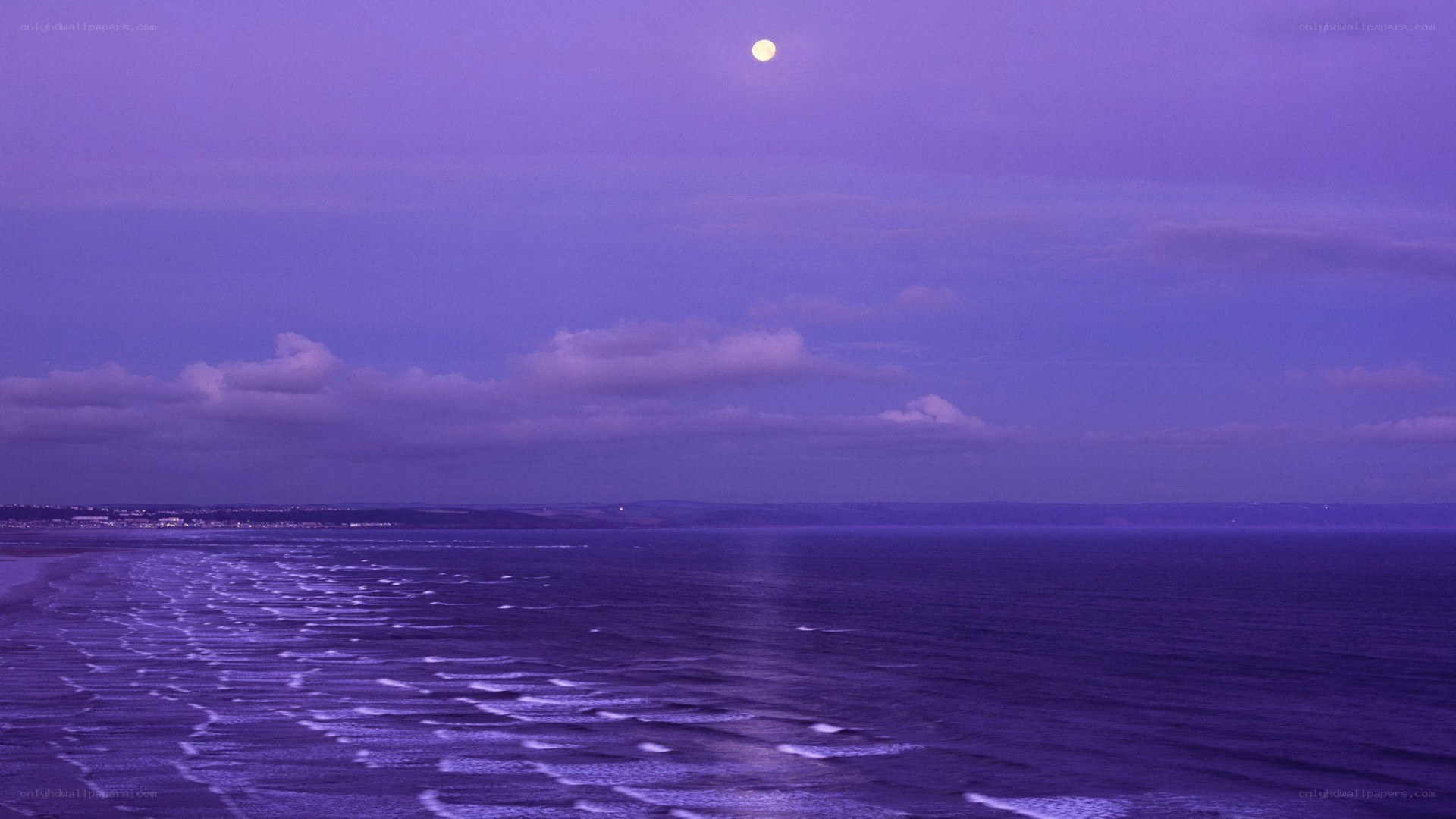 Moon over the ocean at dusk