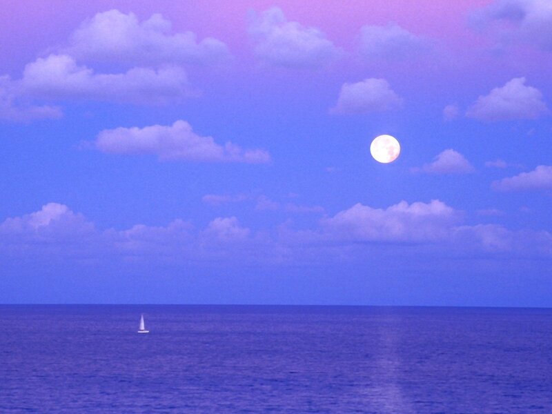 Moon over the ocean at dusk