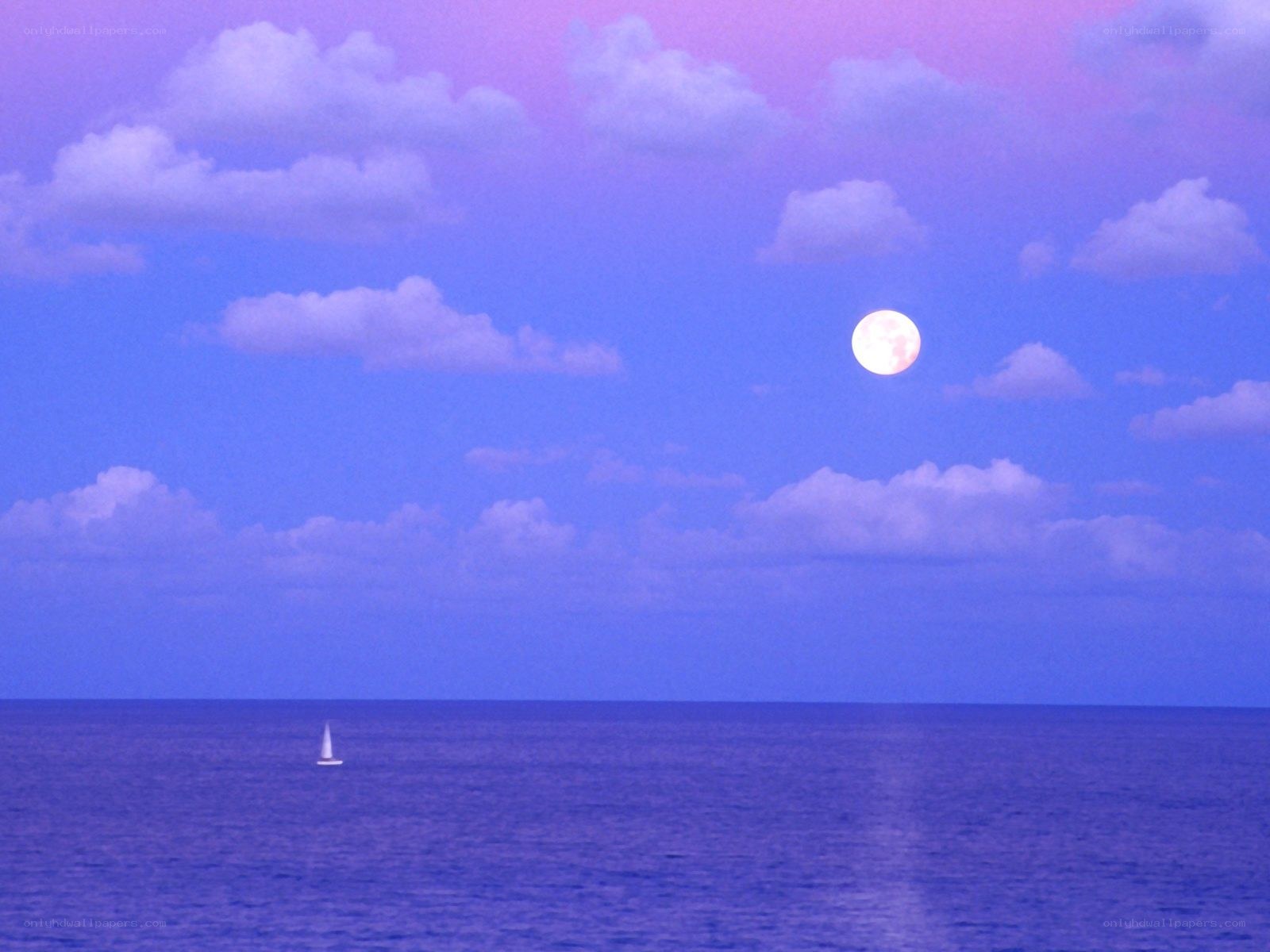 Moon over the ocean at dusk