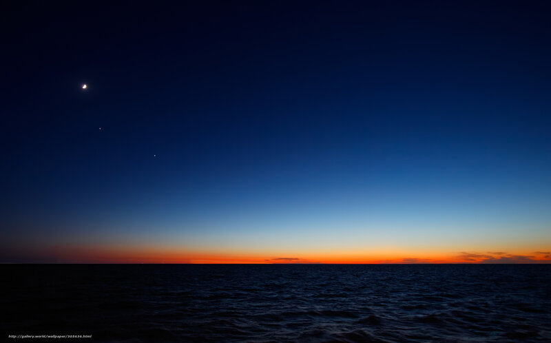 Moon over the ocean at dusk