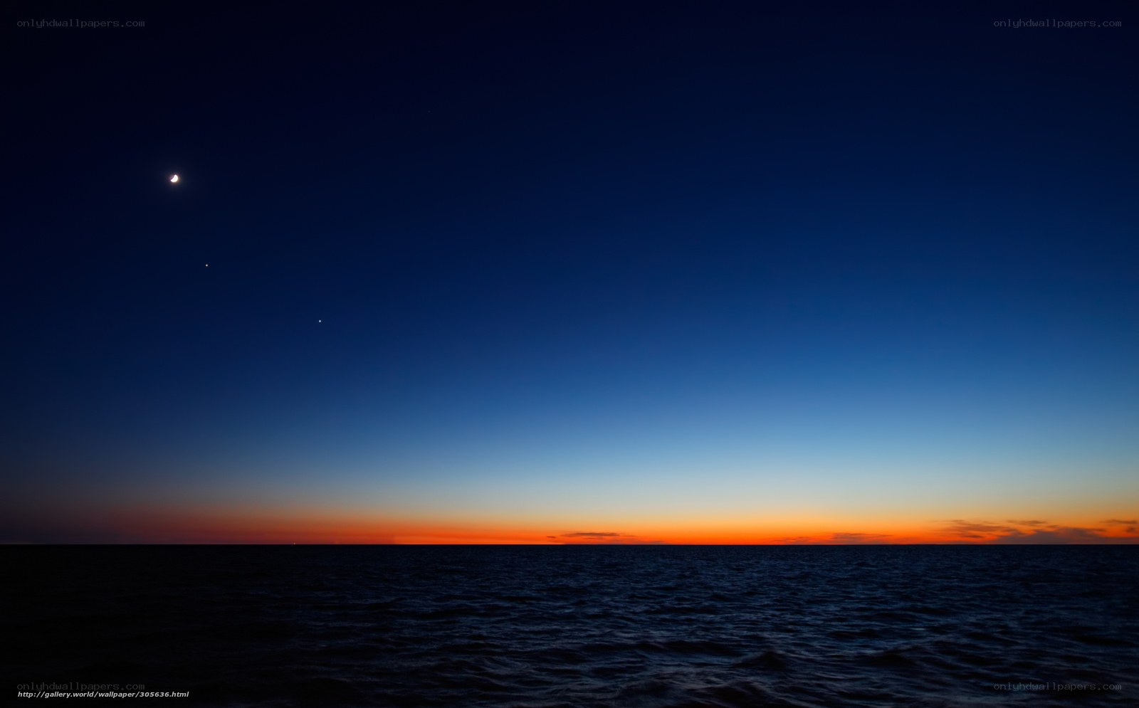 Moon over the ocean at dusk
