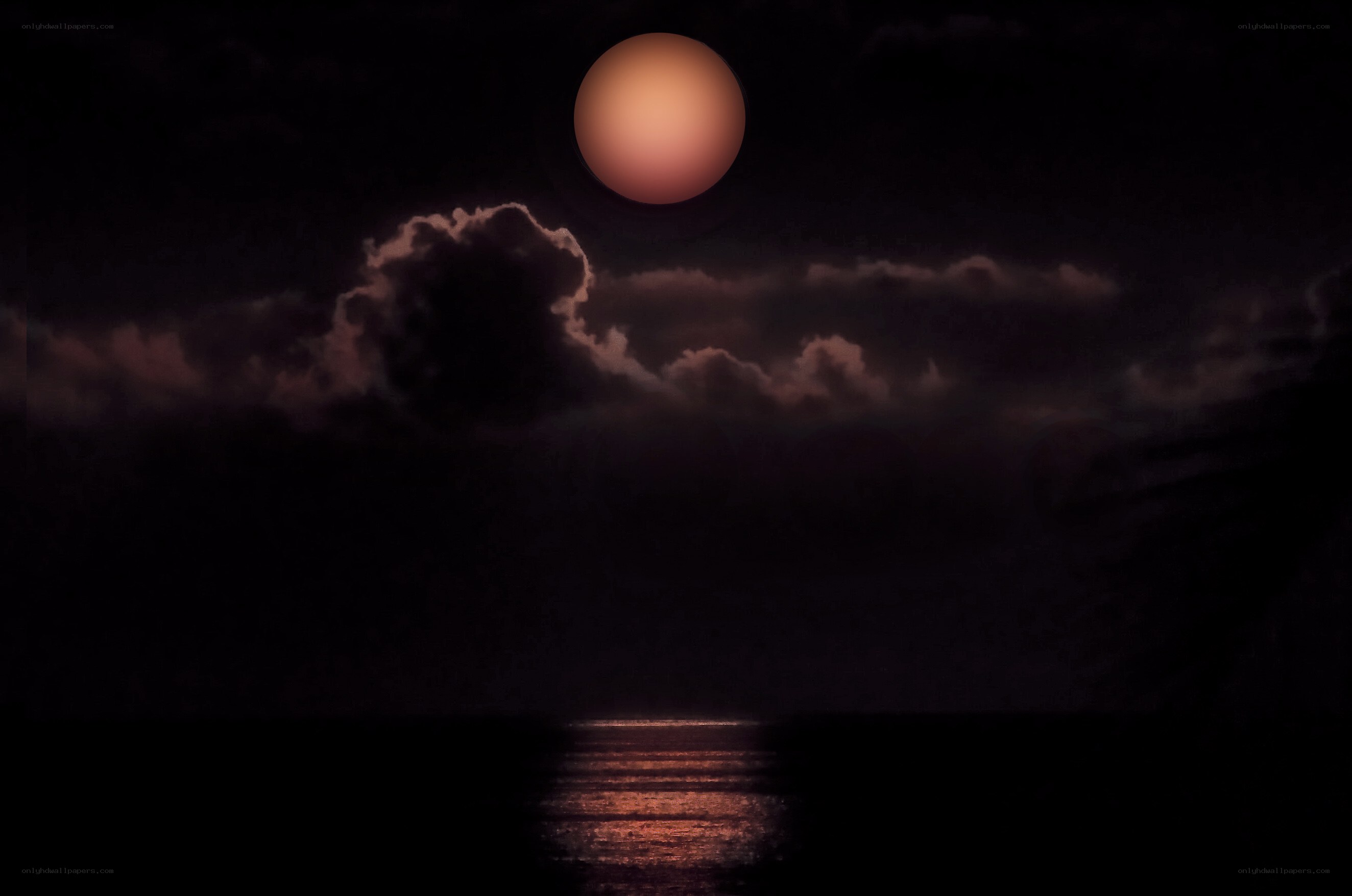 Moon over the ocean at night