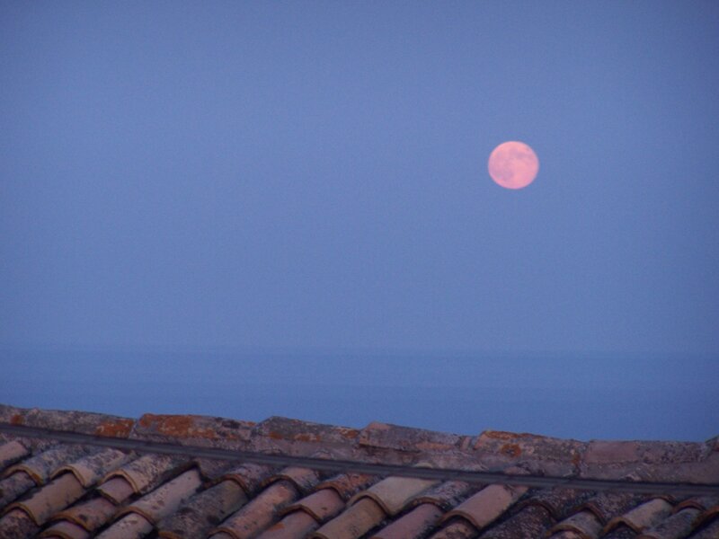 Moon over tiled roof