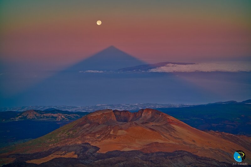 Moon over volcanic landscape