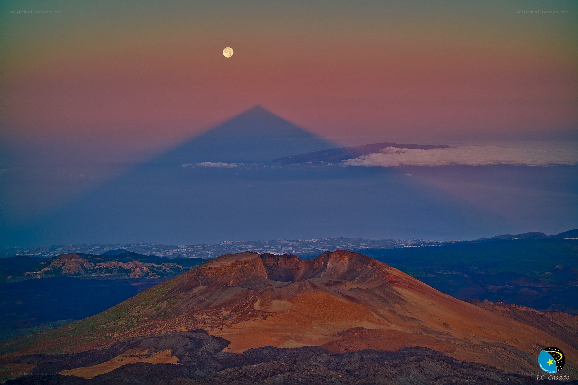 Moon over volcanic landscape