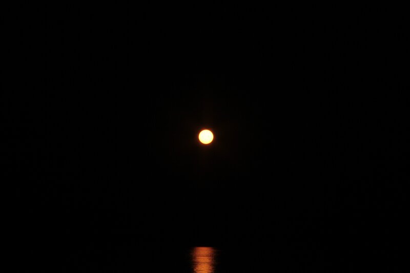 Moon over water at night