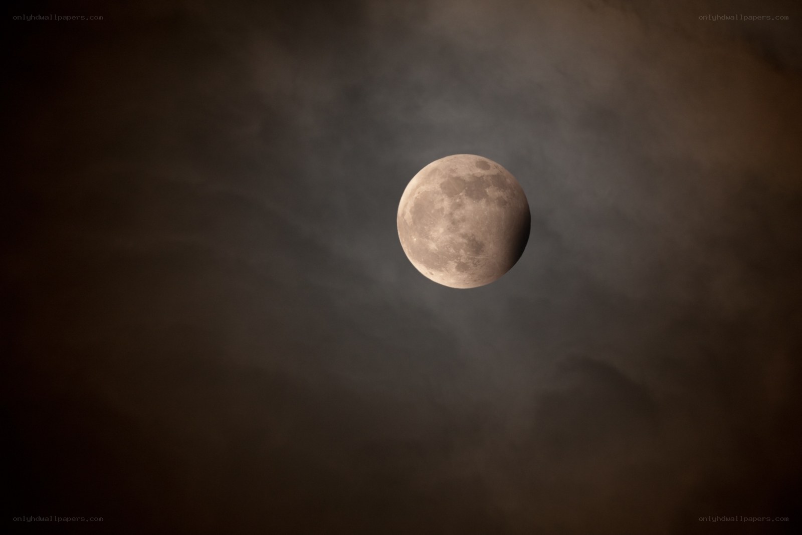 Moon partially obscured by clouds
