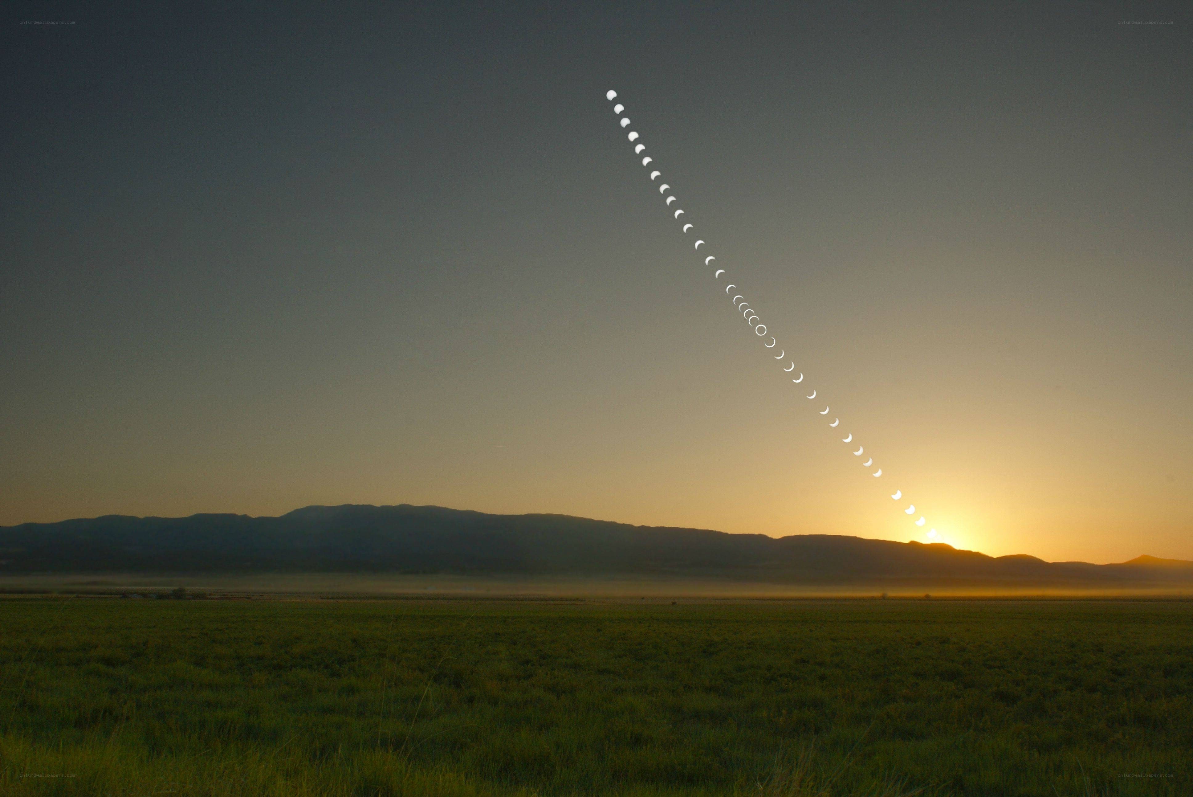 Moon phases over sunrise