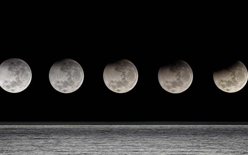 Moon phases over water