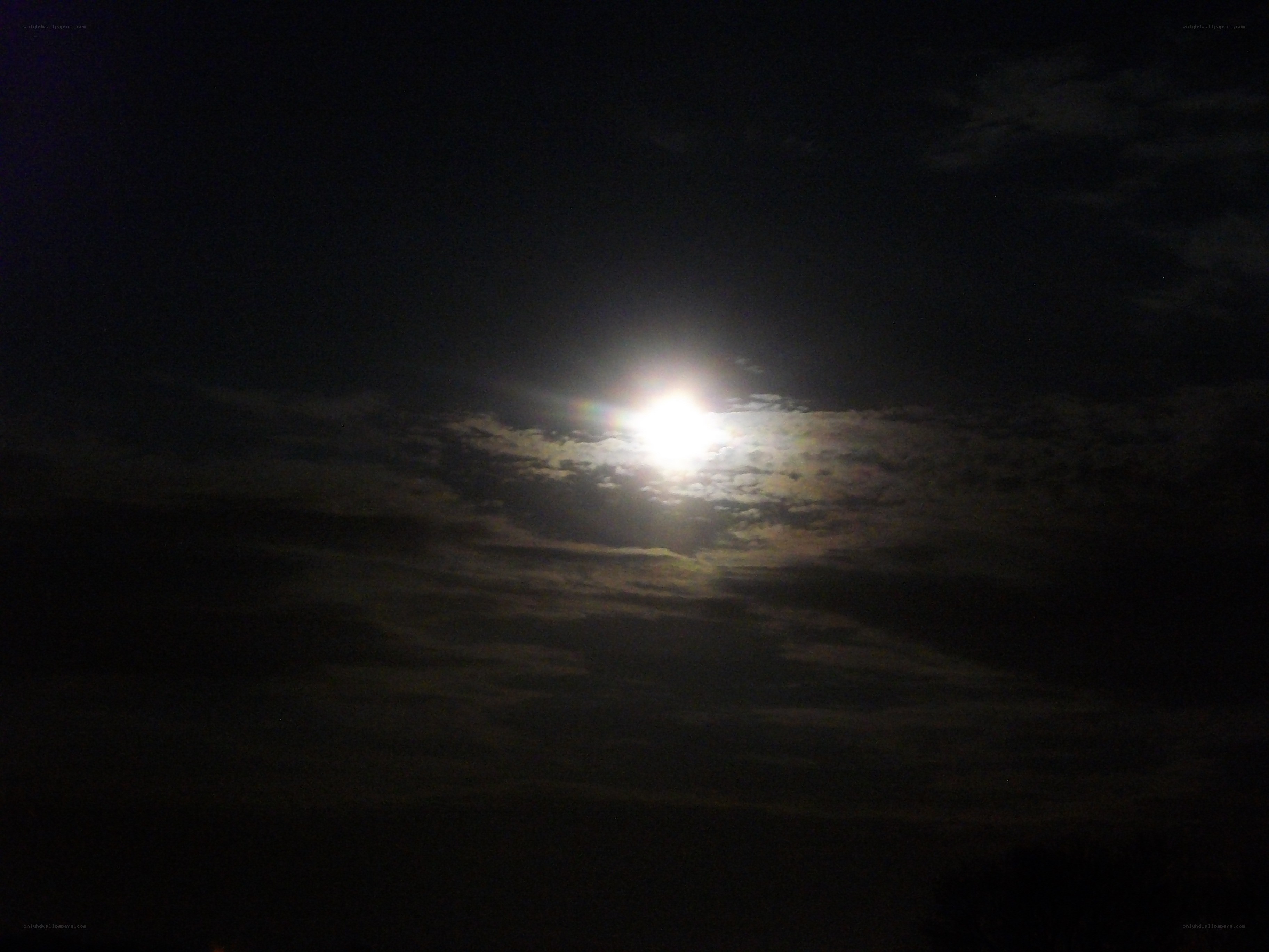 Moon through clouds at night