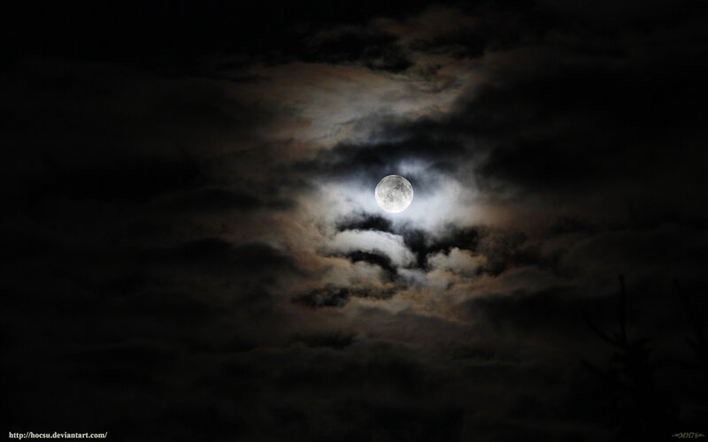 Moon through cloudy night sky