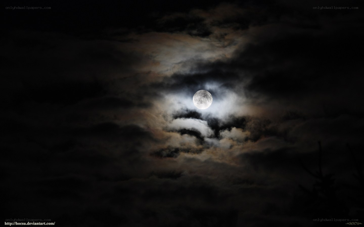 Moon through cloudy night sky