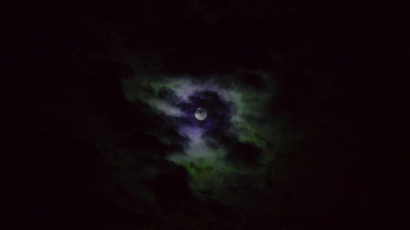 Moon through cloudy night sky
